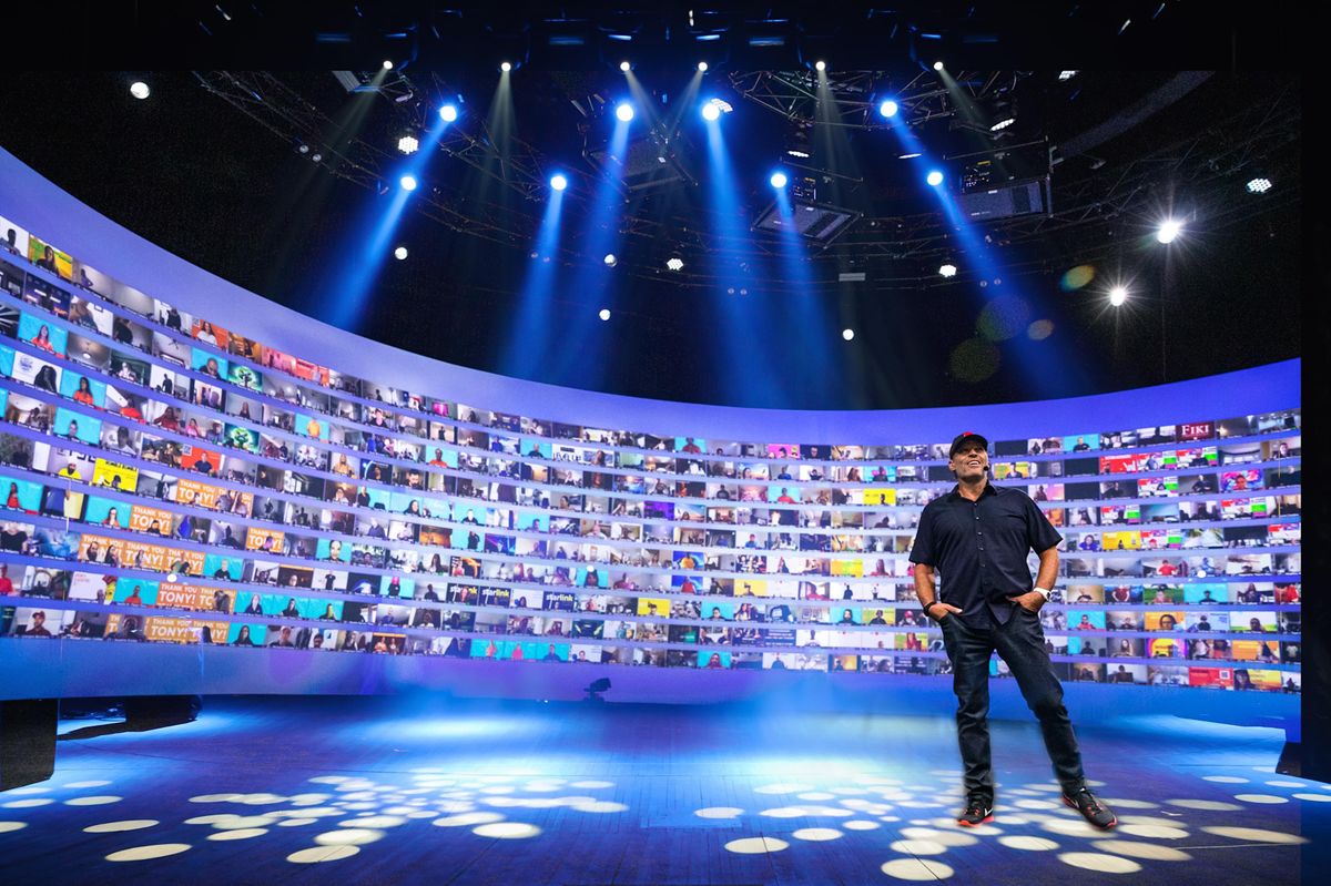 Tony Robbins event with massive screen and audience